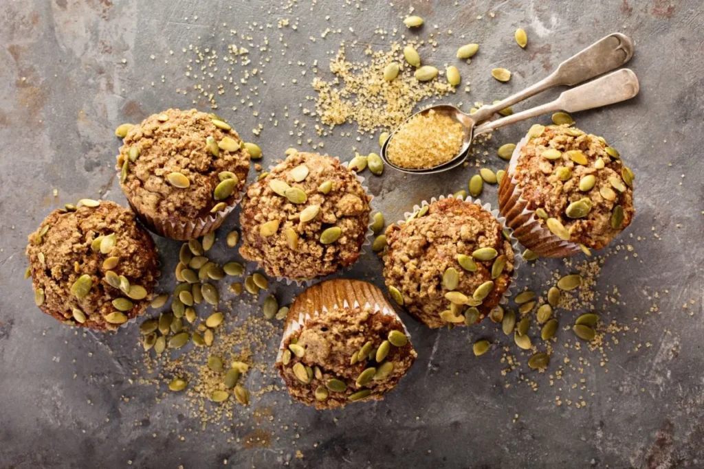 A sliced protein pumpkin muffin revealing a moist texture