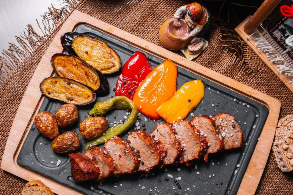 Cooked beef tenderloin tips plated with vegetables