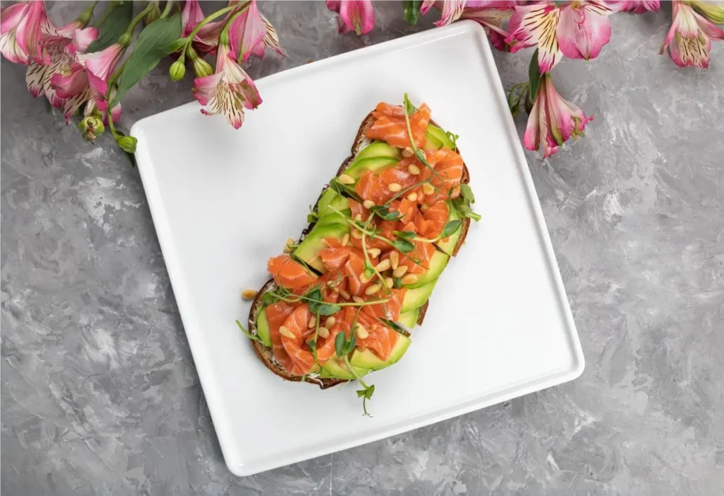 Salmon and avocado toast with red pepper flakes