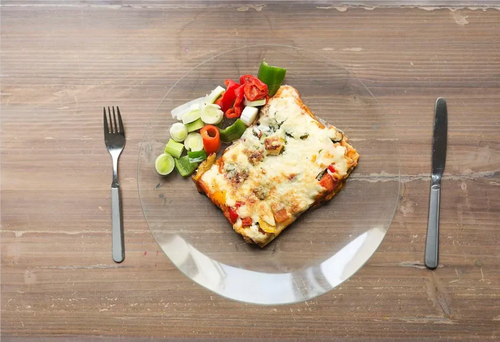 slice of breakfast lasagna with salad- Breakfast Lasagna
