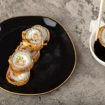 plated chicken tempura roll with dipping sauce